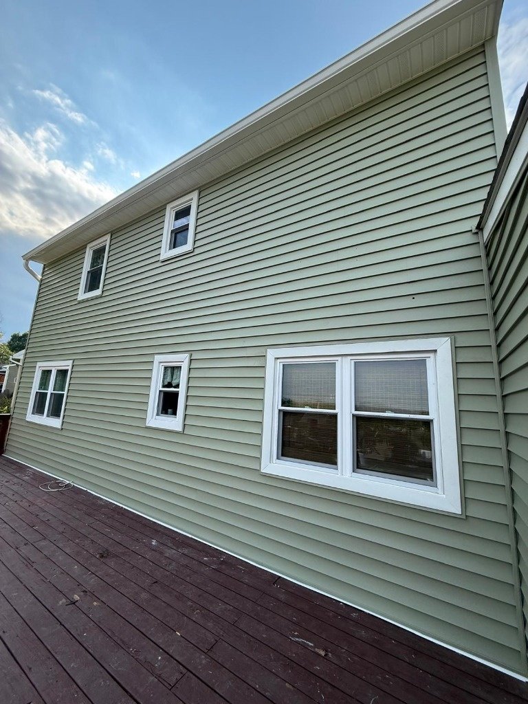 Premium horizontal vinyl siding and custom window capping above deck